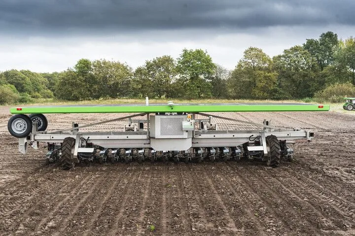 FarmDroid FD60 working across a cultivated field, viewed from behind